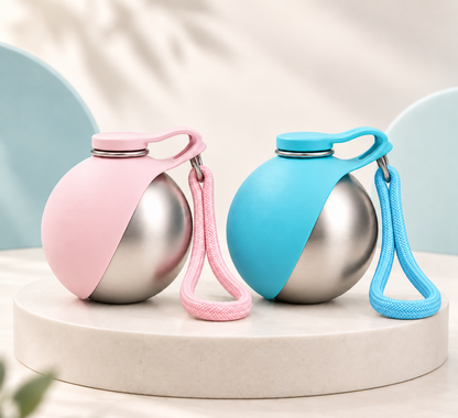 Gorulo Ball Bottle portable pet water bottle in pink and blue on a marble podium